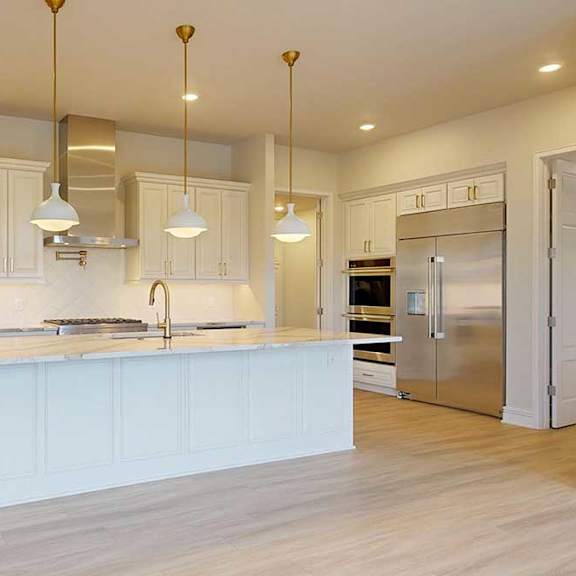 Thumbnail 6 of 31 A kitchen with a white island and stainless steel appliances.