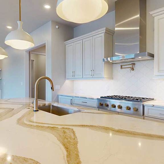 Thumbnail 10 of 31 A modern kitchen with a quartz countertop and premium stainless steel appliances.