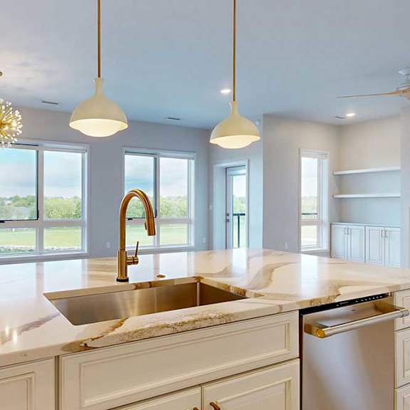 Thumbnail 11 of 31 A kitchen with a marble countertop and a large windows.