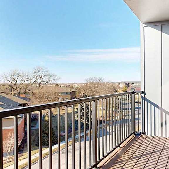 Thumbnail 14 of 30 a balcony with a black metal railing and a view of the Villas at Wilderness Ridge across the street