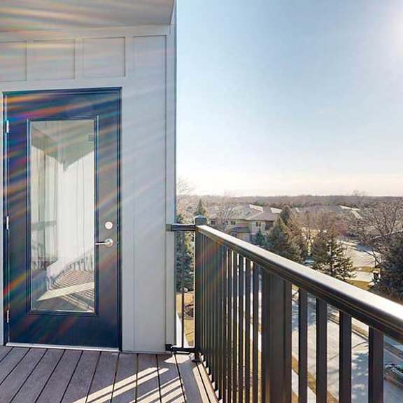 Thumbnail 12 of 30 a balcony with a windowed door leading to the living room and a window from a bedroom