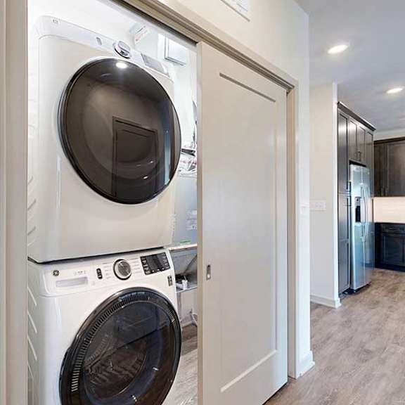 Thumbnail 29 of 30 a stackable washer and dryer in a closet