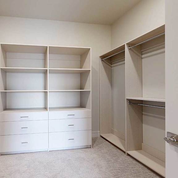 Thumbnail 40 of 41 An oversized, boutique-style walk-in closet with built-in drawers and shelves.