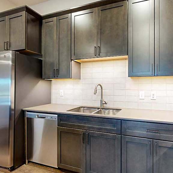 Thumbnail 5 of 26 a kitchen with dark brown cabinets and stainless steel appliances