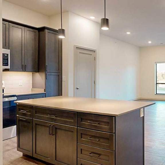 Thumbnail 2 of 26 a view of a spacious living room from a kitchen island countertop