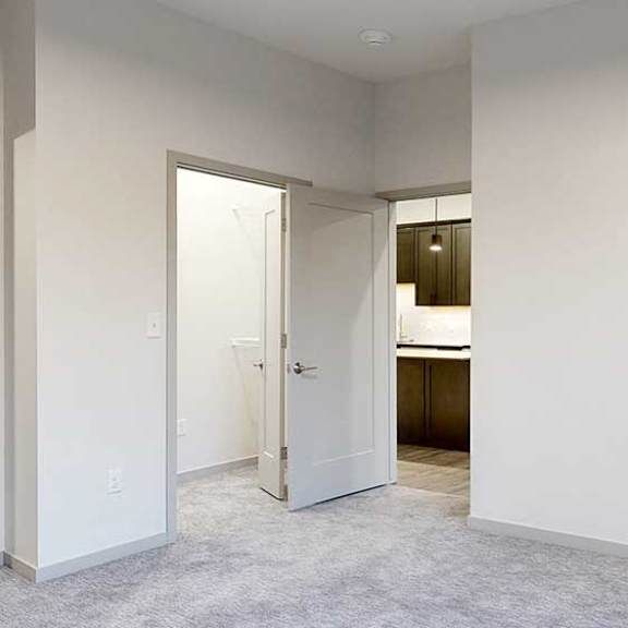 Thumbnail 18 of 25 a bedroom with a carpeted floor and white walls