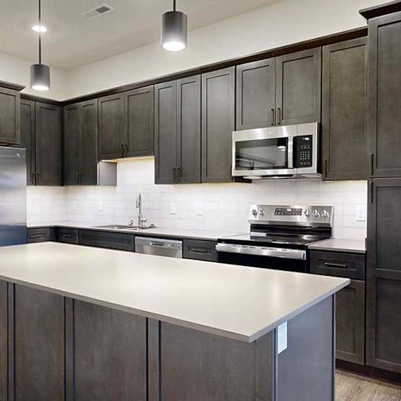 Thumbnail 7 of 25 a modern kitchen with dark wood cabinets and stainless steel appliances