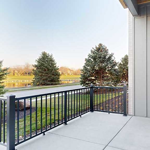 Thumbnail 14 of 25 a walk-out patio with a black railing