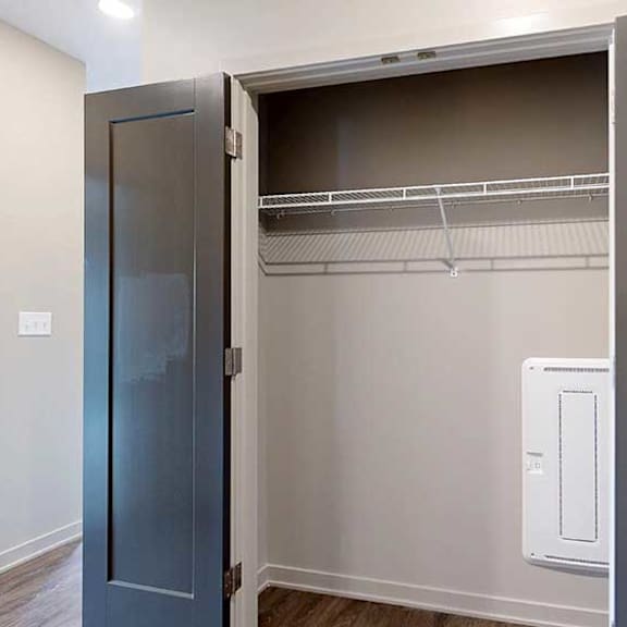 Thumbnail 3 of 33 A large, double-door closet with a wire shelf in the front hallway.