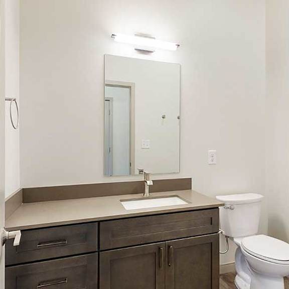 Thumbnail 6 of 33 a bathroom with a quartz vanity sink, a mirror, and a shower tub
