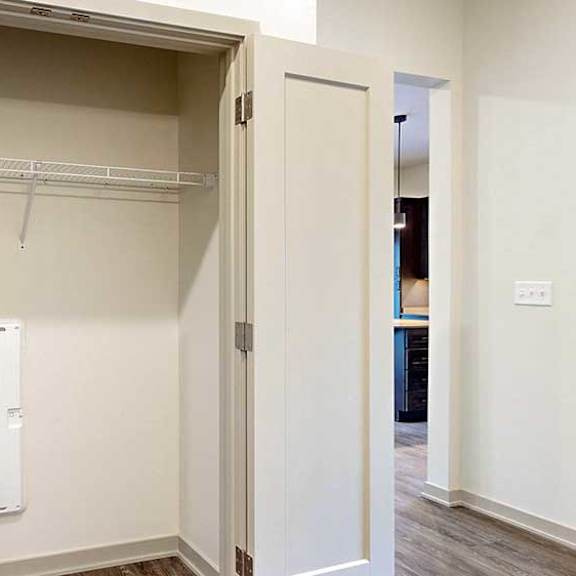 Thumbnail 4 of 33 an open closet with built-in shelving, and double doors
