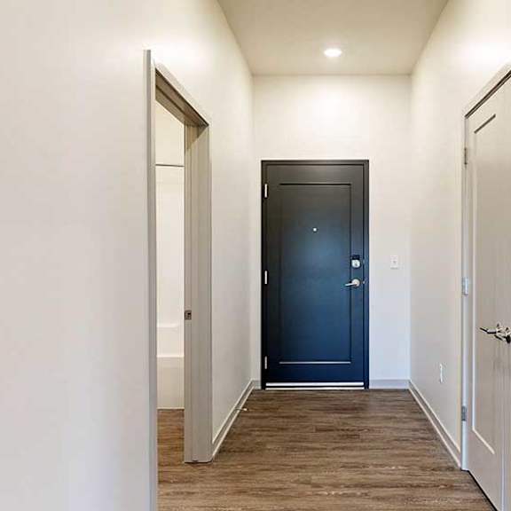 Thumbnail 2 of 33 a front entry hallway with a door to a bathroom and another to a hallway closet