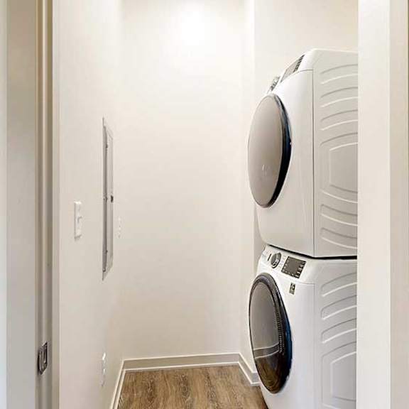 Thumbnail 24 of 33 a stackable washer and dryer in a laundry closet