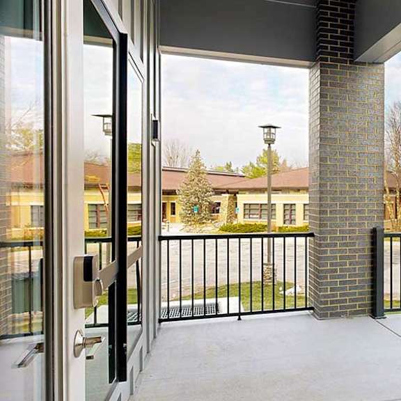 Thumbnail 22 of 33 a balcony with a black metal railing and a brick pillar