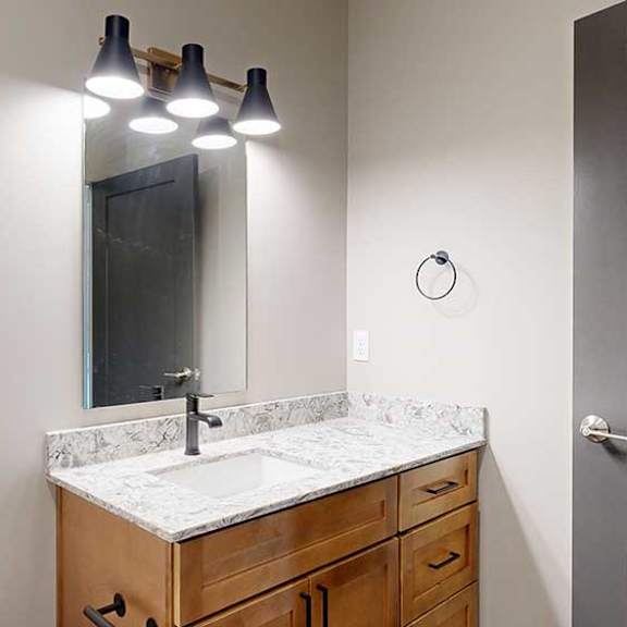 Thumbnail 8 of 33 a bathroom with a white quartz sink and a mirror