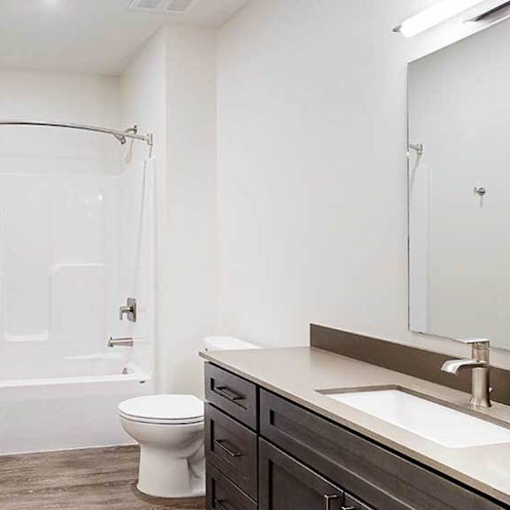 Thumbnail 24 of 25 a bathroom with a white shower and tub