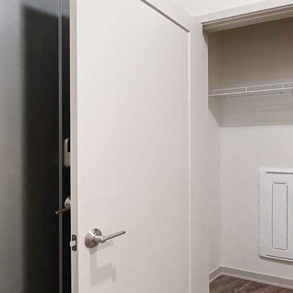 Thumbnail 3 of 25 a coat closet in the hallway with a built in shelf