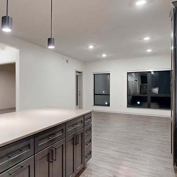 Thumbnail 8 of 25 a kitchen with a large island and dark wood cabinets