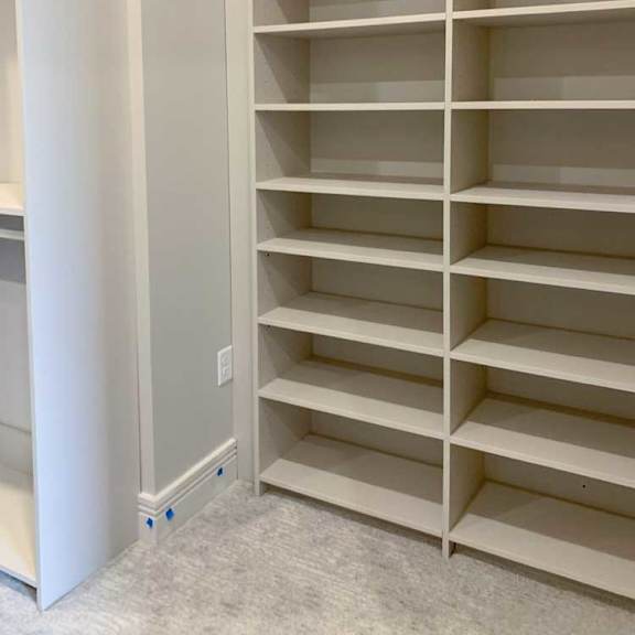 Thumbnail 14 of 26 built-in shelves with several levels in a spacious walk-in closet