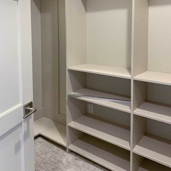 Thumbnail 25 of 26 an additional closet with built-in shelving and hanging spaces, attached to the primary walk-in closet of the primary bedroom