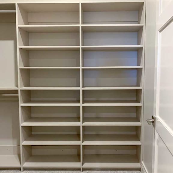 Thumbnail 13 of 26 built-in shelves with several levels in a spacious walk-in closet