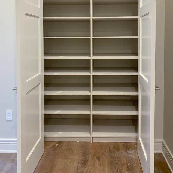 Thumbnail 19 of 26 a hall closet with several built-in shelves