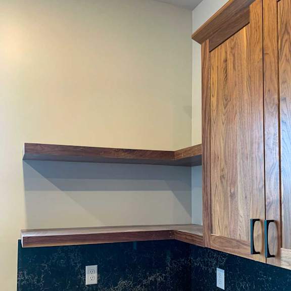 Thumbnail 5 of 26 a kitchen with wooden cabinets and a dark marble backsplash