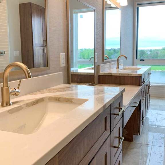 Thumbnail 21 of 26 a bathroom with two marble vanity sinks and three tall mirrors, and a large window at the end