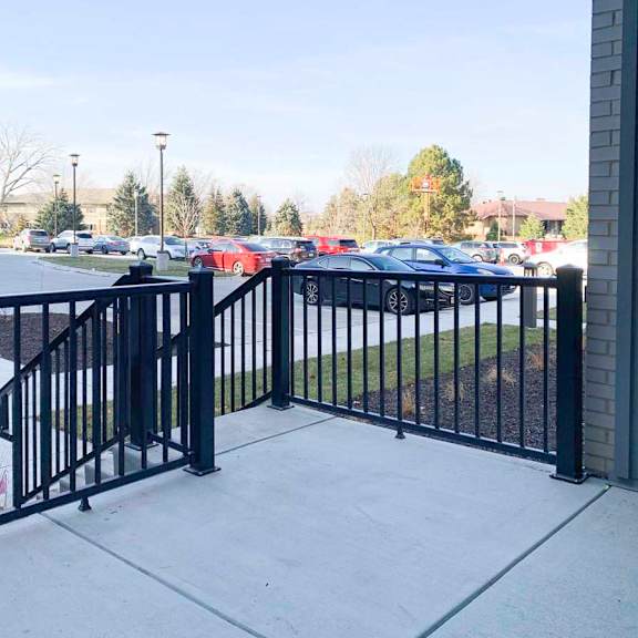 Thumbnail 12 of 29 a black metal railing surrounding a walk-out patio