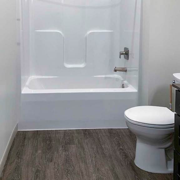 Thumbnail 20 of 29 a bathroom with a combination shower and tub with a built-in curved shower rod