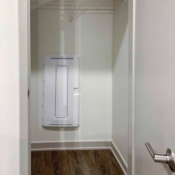 Thumbnail 28 of 29 a coat closet in the front hallway with a built-in wire shelf
