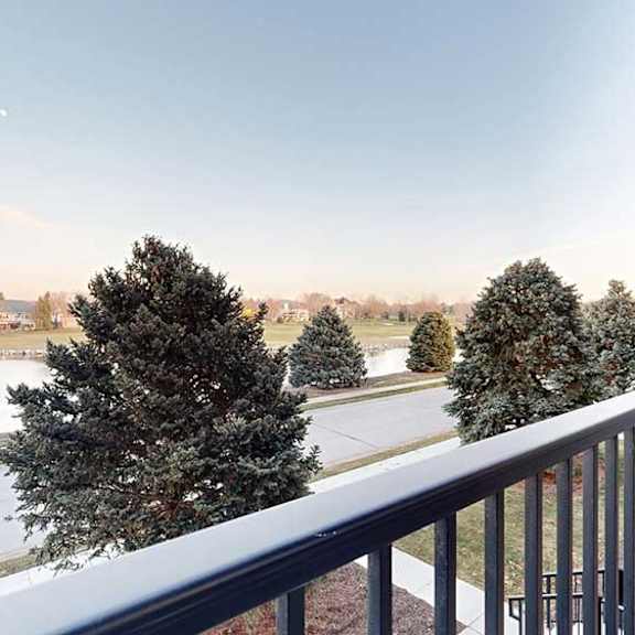 Thumbnail 12 of 26 a balcony overlooks a pond at the neighboring Wilderness Ridge