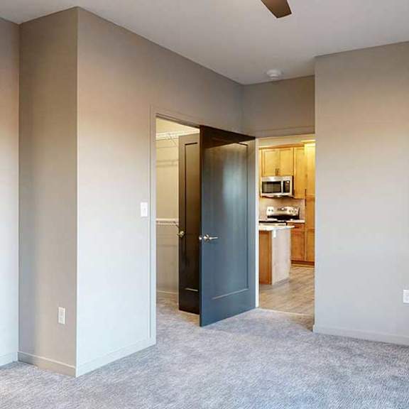 Thumbnail 19 of 26 a bedroom with a carpeted floor, ceiling fan, and walk-in closet