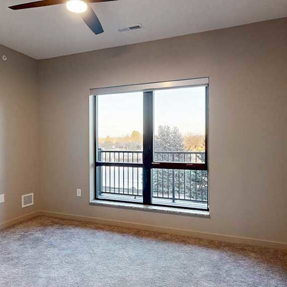 Thumbnail 15 of 26 a bedroom with a window and a ceiling fan