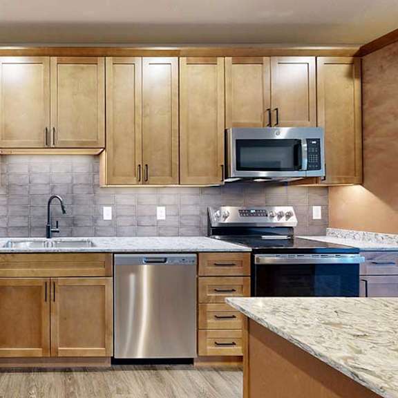 Thumbnail 4 of 26 a kitchen with tan wooden cabinets and stainless steel appliances