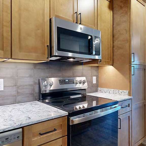 Thumbnail 7 of 26 a kitchen with a stove top oven and microwave above it