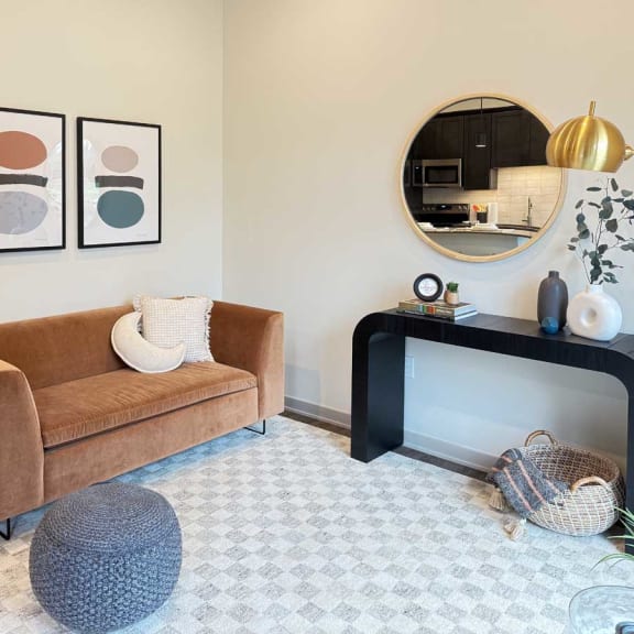 Thumbnail 9 of 20 a cozy living room with a modern velvet couch and other contemporary furniture in the guest suite, available for resident use