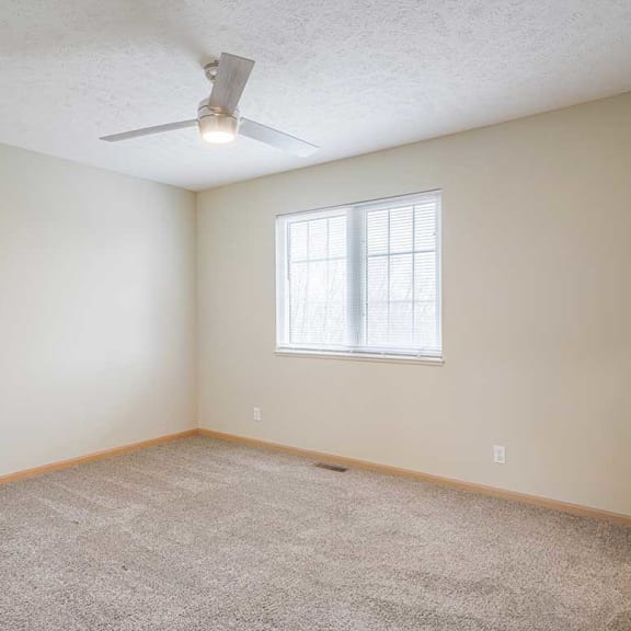 Thumbnail 15 of 26 a bedroom with a ceiling fan and a window