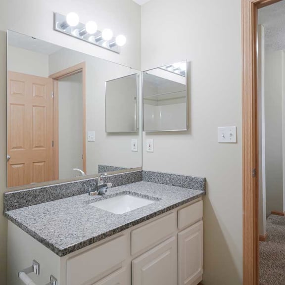 Thumbnail 21 of 26 a bathroom with a large vanity sink and mirror