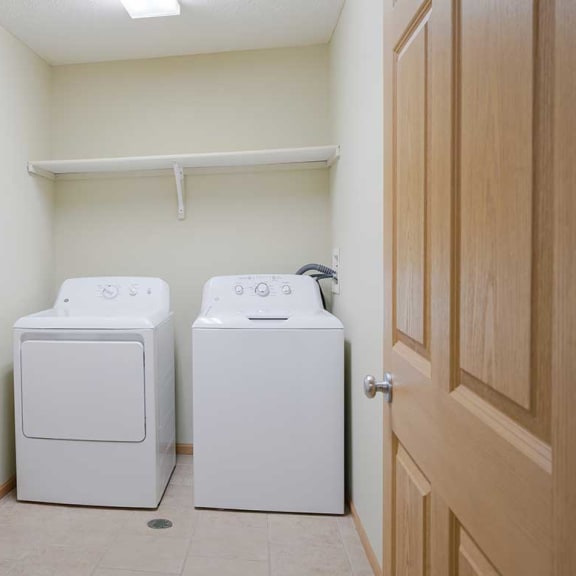 Thumbnail 23 of 26 a washer and dryer in the laundry room with overhead storage
