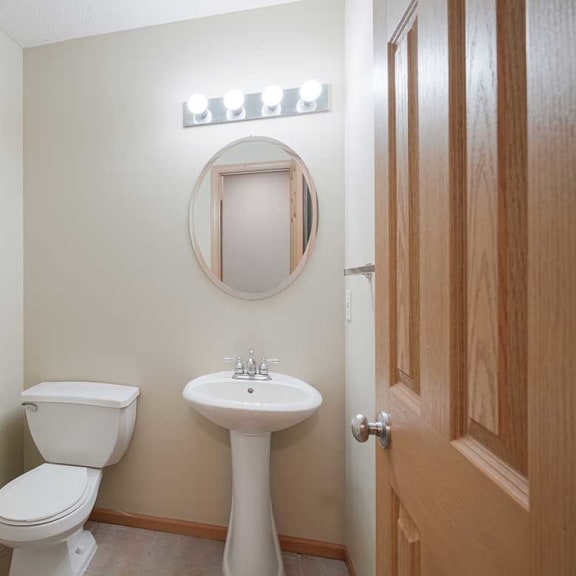 Thumbnail 13 of 26 a half bathroom with a sink and toilet