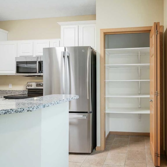 Thumbnail 10 of 26 a kitchen with white cabinets and a large pantry