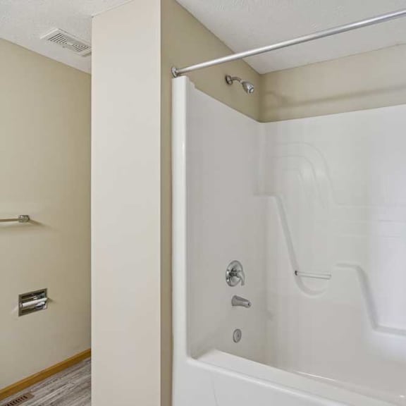 Thumbnail 50 of 54 A white bathtub with a shower head and faucet.
