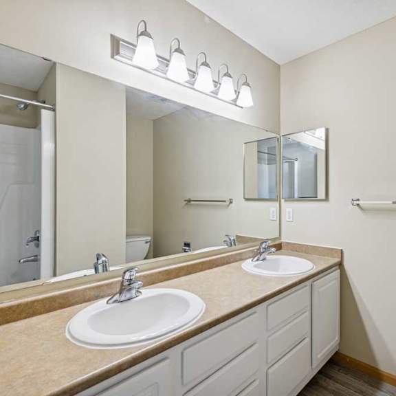 Thumbnail 30 of 54 A bathroom with two sinks and a large mirror.