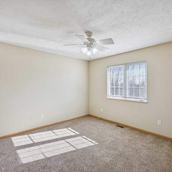 Thumbnail 31 of 54 A room with a ceiling fan and a window with blinds.