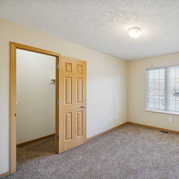 Thumbnail 43 of 54 A room with a door and a window with blinds.