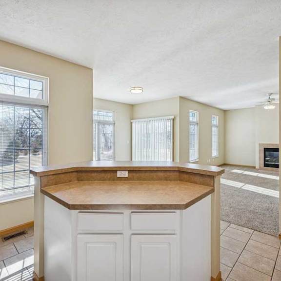 Thumbnail 51 of 54 A kitchen with a white countertop and cabinets.