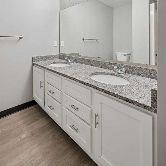 Thumbnail 20 of 79 A bathroom with a sink, mirror, and lighting fixture.
