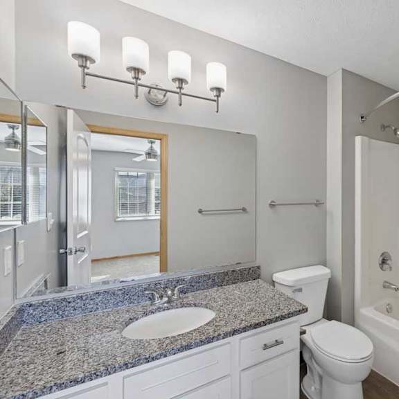 Thumbnail 16 of 79 A bathroom with a sink, toilet, and bathtub.
