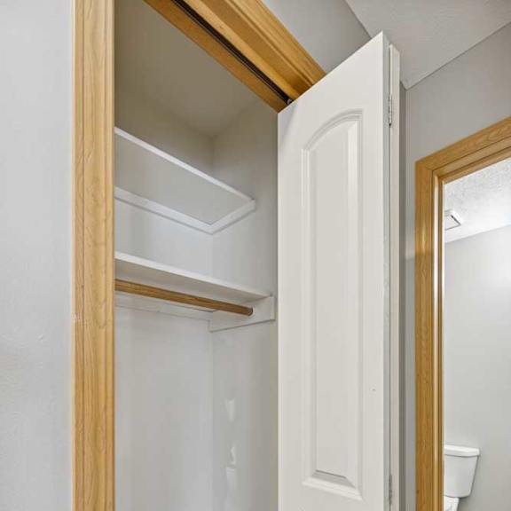 Thumbnail 27 of 79 A white door is open to a small, empty room.